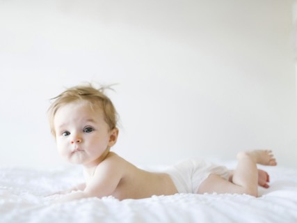 Baby girl (6-11 months) playing in bedroom