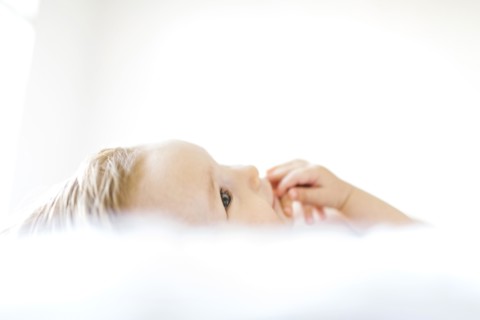 Baby girl (6-11 months) playing in bedroom