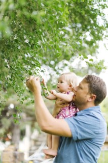 Father playing with baby girl (12-17 months) in backyard