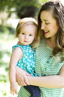 Portrait of mother and baby girl (12-17 months) in backyard