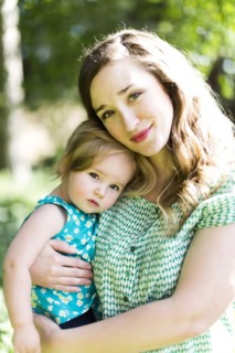 Portrait of mother and baby girl (12-17 months) in backyard