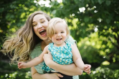 Portrait of mother carrying daughter (12-17 months)