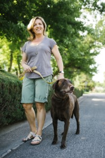 Woman walking with Labrador Retriever