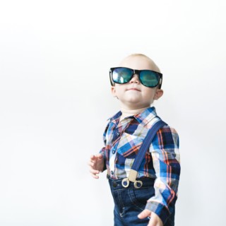 Studio shot of baby boy (12-17 months) wearing sunglasses