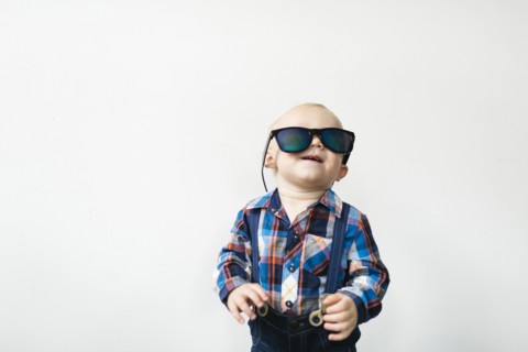 Studio shot of baby boy (12-17 months) wearing sunglasses