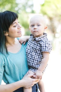 Mother carrying baby boy (12-17 months)