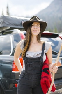 Outdoor portrait of smiling woman wearing hat