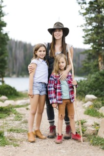 Outdoor portrait of mother with kids (6-7, 8-9) in forest