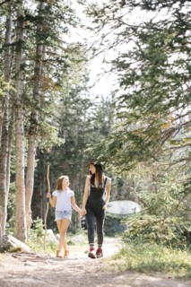 Mother with daughter (8-9) hiking in forest