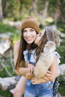 Portrait of mother with daughter (8-9) hiking in forest