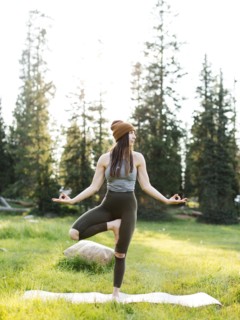 Woman practicing yoga in forest