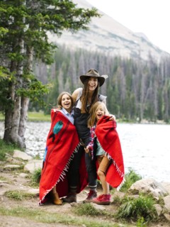 Woman with son (6-7) and daughter (8-9) standing by lake