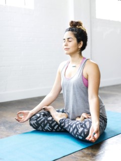 Woman meditating in lotus position