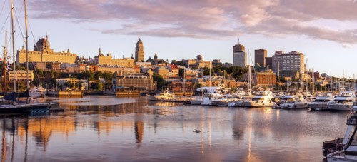 Canada, Quebec, Quebec City, Coastline with marina and buildings reflected in water