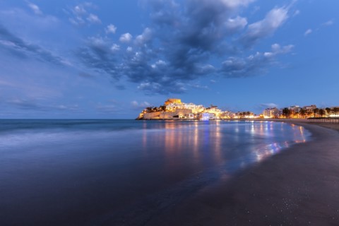 Spain, Valencian Community, Peniscola, Illuminated town by sea