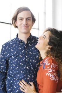 Portrait of couple against window
