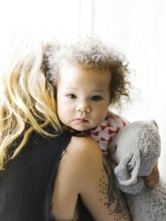 Mother embracing daughter (12-17 months)