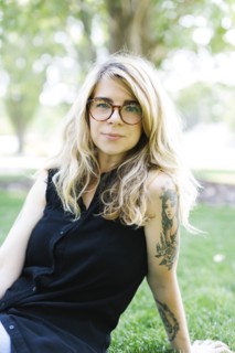 Blonde woman sitting on grass