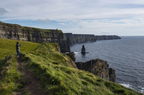 Ireland, Clare County, Woman looking at view on Cliffs of Moher