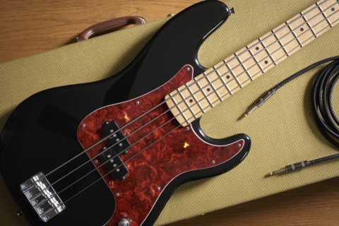 Bass guitar and cable lying on guitar case