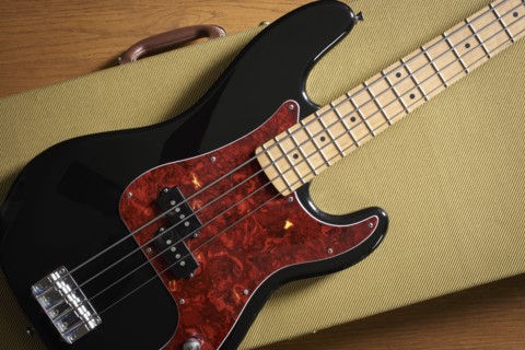 Bass guitar lying on guitar case