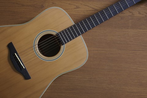 Acoustic guitar lying on floor