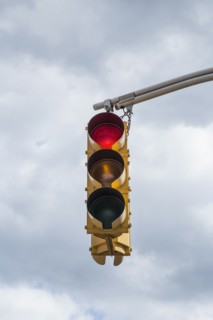 Traffic light against storm clouds