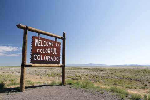 USA, Colorado, New Mexico, Border Highway 285, Blue sky over information sign