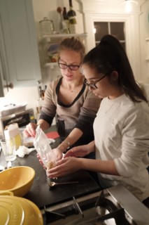 Mother and daughter cooking in kitchen