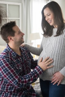 Pregnant woman and partner looking at each other