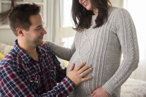 Man touching pregnant partner