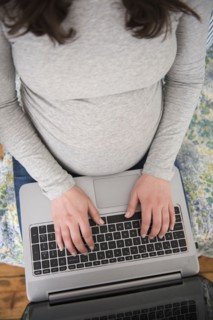 High angle view of pregnant woman using laptop
