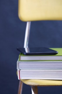 Close up of tablet and books on chair