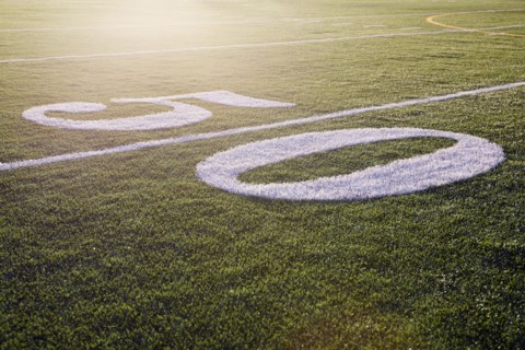 Fifty yard line on green playing field