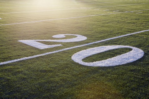 Twenty yard line on green playing field