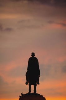 Spain, Seville, Plaza Nueva, Silhouette of equestrian statue of King Fernando III