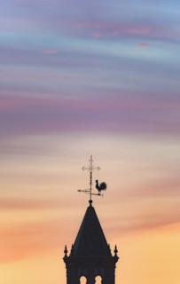 Spain, Andalusia, Seville, Weathercock on top of tower at sunset