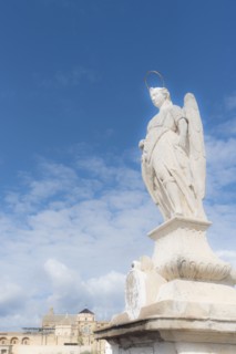 Spain, Andalusia, Cordoba, Statue of San Rafael against clouds