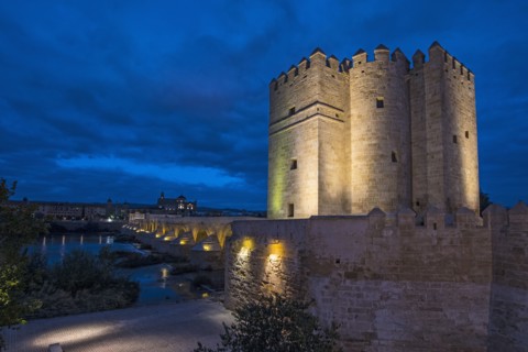 Spain, Andalusia, Cordoba, Illuminated, old church near bridge over Guadalquivir river