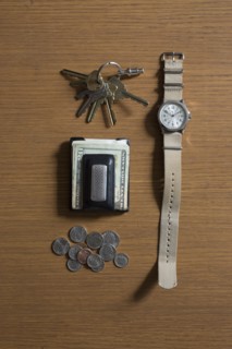 Watch, keys and money on table