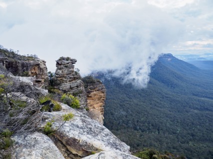 Australia, New South Wales, Katoomba, Large rocks and mountains in clouds