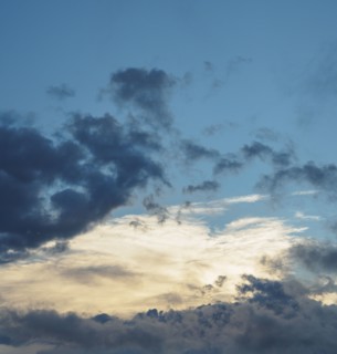 Blue sky with storm clouds at sunset