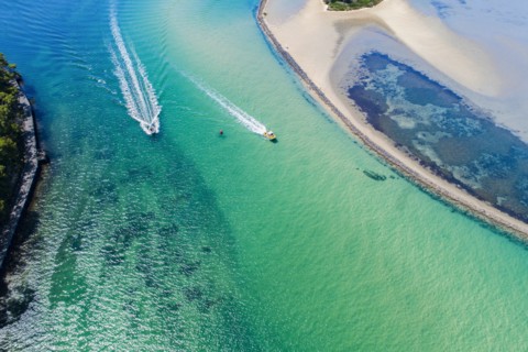 Australia, New South Wales, Narooma, Aerial view of speedboats and inlet