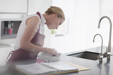 Woman preparing meal in kitchen