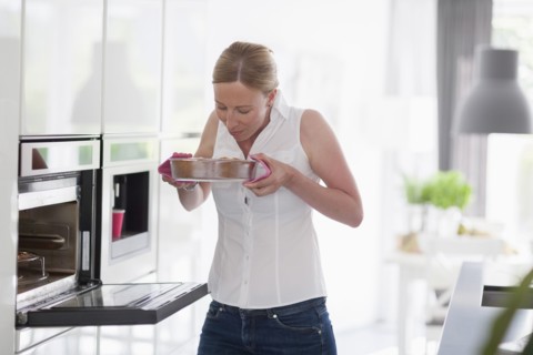 Woman smelling freshly baked cake