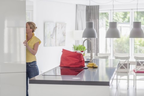 Woman unpacking groceries from shopping bag
