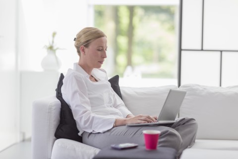 Woman using laptop in living room