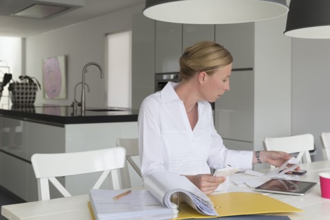 Mature woman working at table