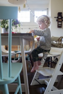 Boy at table on step ladder