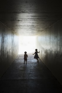 Silhouettes of children in tunnel
